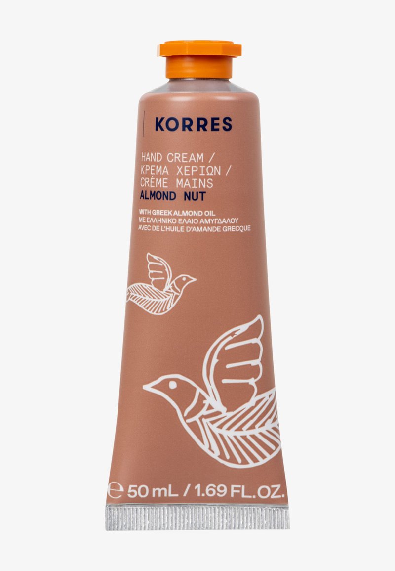 Tube de crème pour les mains Korres, 50 mL, présente une couleur terracotta mate, un capuchon orange, un graphique d'oiseau blanc et des étiquettes en plusieurs langues.