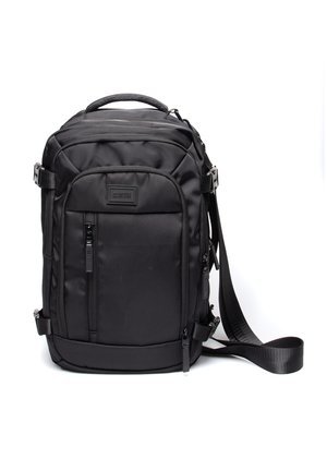 Black backpack made of durable fabric, featuring a padded handle, adjustable shoulder strap, multiple zippered pockets, and a sleek design.