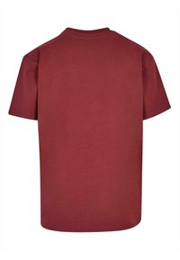 Maroon cotton T-shirt featuring a classic crew neck, short sleeves, and a straight hem; smooth texture with no visible patterns or accents.