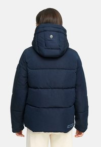 Navy blue puffer jacket with a quilted design, a hood, and a logo on the back. Features padded sections and elastic cuffs, made of synthetic material.