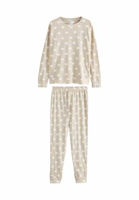 Beige pyjamaset med långärmad topp och byxor. Tyget har ett upprepat mönster av vita pumpor. Elastisk midja på byxorna.