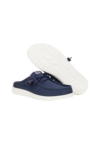 Marineblauwe canvas instap schoenen met een wit gespikkelde rubberen zool, voorzien van een eenvoudig ontwerp en verstelbare veters bovenaan.