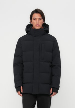 Black insulated puffer jacket with a high collar, front pocket, and hood. Smooth texture, quilted pattern, and folded cuffs.