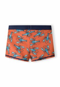 Shorts de bain avec un fond orange vif présentant un motif répétitif de homards bleus. La ceinture et les bordures sont bleu marine.