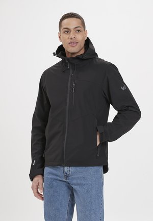 Black softshell jacket with a zip front, adjustable hood, and side pockets. Features a textured finish and logo on the sleeve.