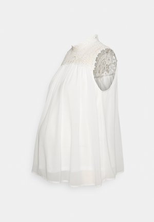 White sleeveless top with a high lace collar and sheer fabric. Features a flowing design with gathered waist and shoulder cutouts.