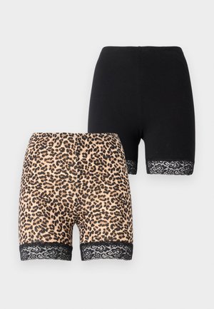 Two pairs of shorts: one in solid black fabric, the other in a tan leopard print with a black lace trim at the hem. Both are mid-length.