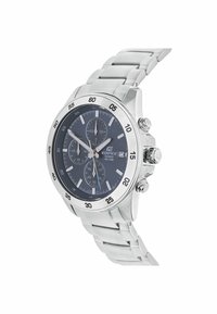 Silver stainless steel chronograph watch with a dark blue dial, luminous hands, and a tachymetric bezel. Features three sub-dials and a multi-link bracelet.