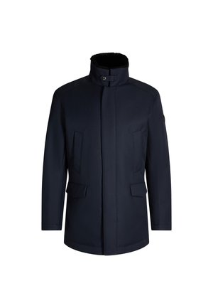 Navy blue outerwear jacket with a high collar, two front pockets, and a straight cut. Features a smooth texture and simple design.