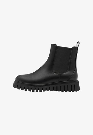 Black leather chelsea boots with elastic side panels, pull tab, and thick rubber lug sole. Smooth texture with minimalistic design.