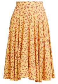 Keltainen kukkakuvioinen hame, jossa liehuva malli ja pienet punaiset ja valkoiset kukat. Valmistettu pehmeästä kankaasta, sileä pintakäsittely ja joustava vyötärö.