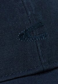 Dark blue baseball cap with a textured fabric; features a stitched logo in darker blue, emphasizing the quality of the material and design.