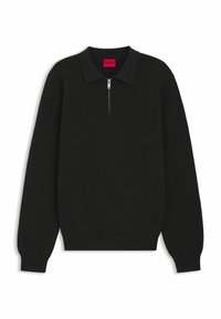 Maglione zip-up nero con colletto a polo, texture a coste, maniche lunghe e branding sottile sull'orlo. Il materiale appare lavorato a maglia e resistente.