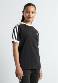 Black athletic t-shirt with white accents, short sleeves, and a crew neckline. Features three white stripes on each sleeve and a small logo.
