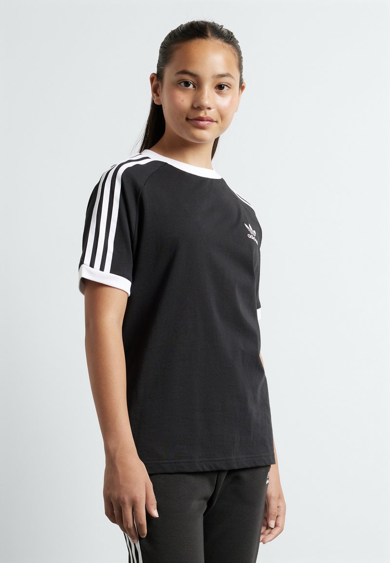 Black athletic t-shirt with white accents, short sleeves, and a crew neckline. Features three white stripes on each sleeve and a small logo.