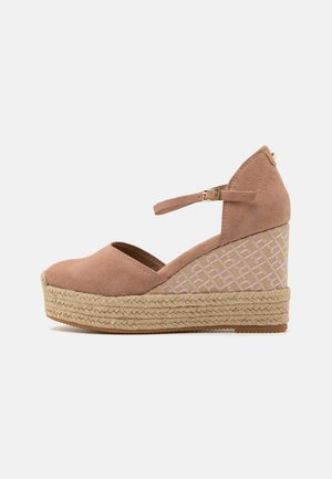 Pink suede espadrille wedge with a woven patterned side, a round toe, and an ankle strap, featuring a jute-wrapped platform sole.