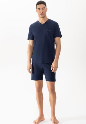 Navy blue men's loungewear set made of soft fabric, featuring a short-sleeve V-neck shirt with a chest pocket and matching shorts.