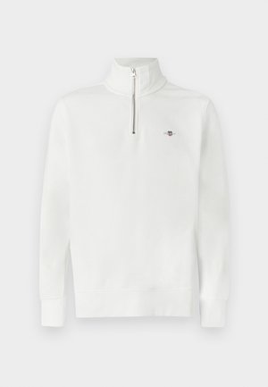 White pull-over sweatshirt, half-zip collar, long sleeves, cotton material, subtle logo detail on chest. Smooth texture, relaxed fit.