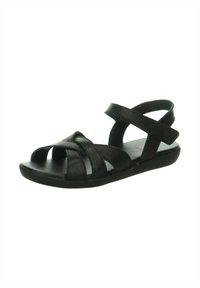 Schwarze Sandalen mit flacher Sohle, mit einem Riemchen-Design und offenen Zehen. Hergestellt aus strukturiertem Leder mit überkreuzten Riemen für zusätzliche Unterstützung.