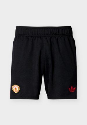 Black athletic shorts with elastic waistband, Manchester United logo on left leg, and red Adidas trefoil logo on right leg.