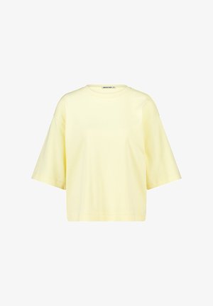 Light yellow oversized short-sleeve t-shirt with a round neckline and a slightly cropped hem.