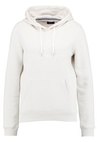 Valkoinen puuvillainen huppari, jossa on nyörisäädettävä huppu, etupuolella kengurutasku ja rinnassa kirjailtu "GANT"-logo. Resorit hihansuissa ja helmassa.