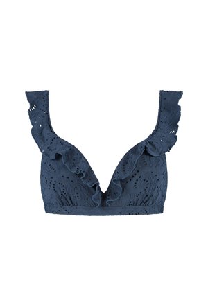 Bralette en dentelle bleu marine avec un décolleté plongeant en V, des volants le long des épaules et des motifs découpés complexes partout.