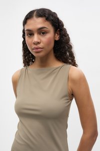 Fitted sleeveless top in beige, made from smooth, stretchy fabric. Features a round neckline and seamless design for a sleek appearance.