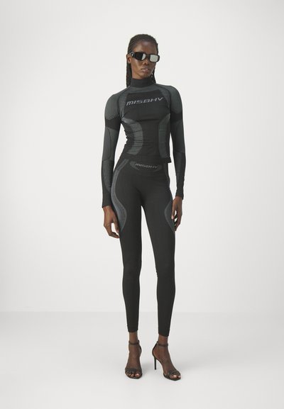 Black athletic set featuring a long-sleeve top with a mock neck and textured accents, paired with fitted leggings. Both have logo detailing.