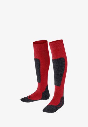 Czerwone skarpetki do kolan z ciemnoszarym wzmocnieniem w okolicy łydki i stopy. Wykonane z teksturowanego materiału z prążkowanymi mankietami.