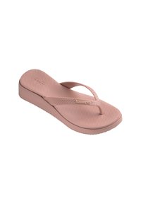 Infradito rosa in gomma con suola testurizzata e fasce sottili. Presenta una suola a piattaforma bassa e logo impresso sul lato.