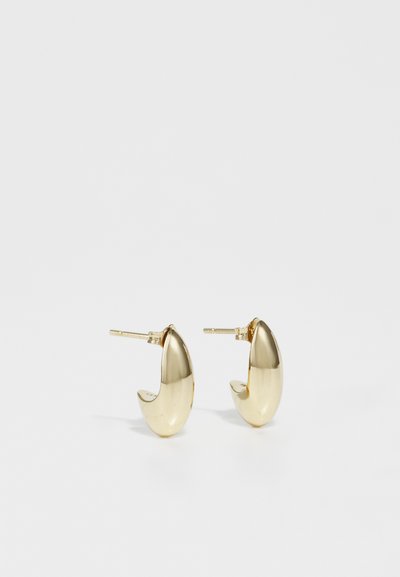 Gold-tone metal earrings with a sleek, curved design, featuring a polished, shiny surface and a secure post closure.