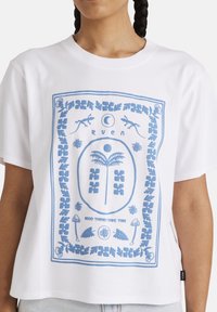 Witte t-shirt met korte mouwen, voorzien van een blauwe grafische print met bloemen- en natuurelementen, inclusief een palmboom en de zin "Goede dingen hebben tijd nodig."