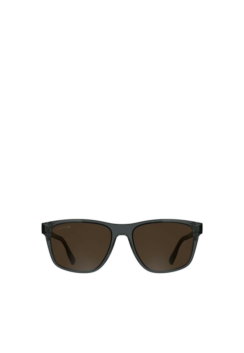 Black sunglasses with brown tinted lenses, rectangular shape, and clear plastic frames. Features logo on the upper left lens.