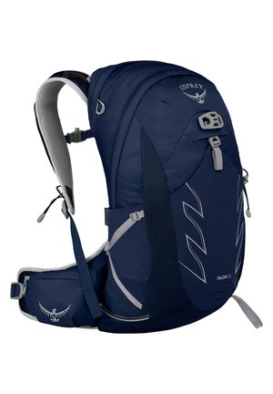 Sac à dos bleu marine avec un tissu texturé, de forme incurvée, des bretelles ajustables et plusieurs compartiments. Présente des accents réfléchissants et un logo.