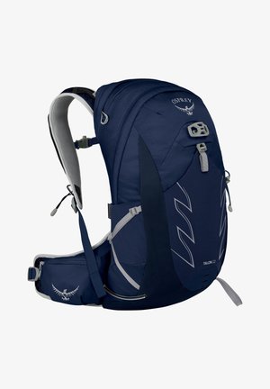 Sac à dos bleu marine avec un tissu texturé, de forme incurvée, des bretelles ajustables et plusieurs compartiments. Présente des accents réfléchissants et un logo.