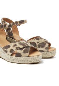 Leopard-printed espadrille sandals with cross-strap design, soft suede material, natural jute sole, and a light brown cushioned footbed.
