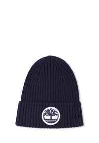 Bonnet en tricot marine avec texture côtelée et bord replié, présentant un patch circulaire blanc avec un logo d'arbre à l'avant.