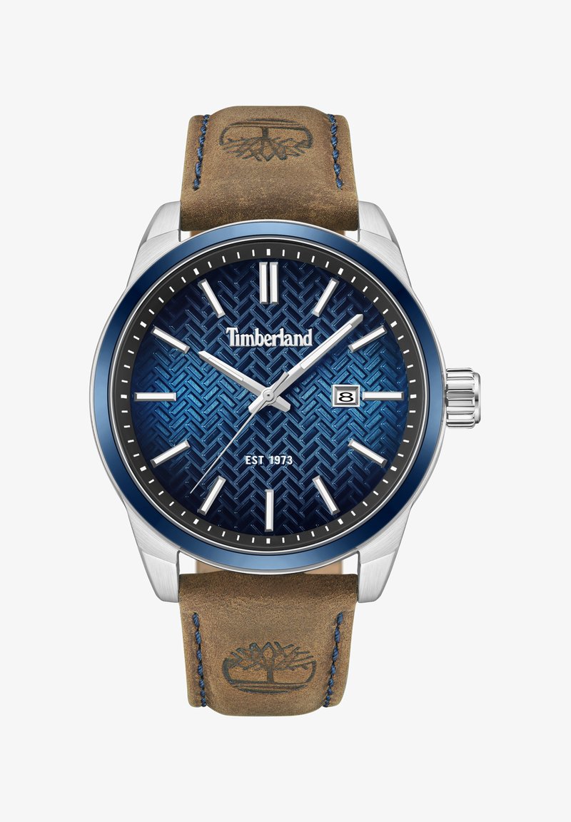 Timberland laikrodis su mėlynu raštuotu skydeliu, sidabriniu nerūdijančio plieno korpusu, datos rodymu ir tan odiniu dirželiu su logotipo įspaudu.