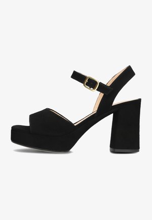 Black suede high-heeled sandals with a platform, peep toe, ankle strap, and gold-tone buckle detail. Chunky block heel for support.