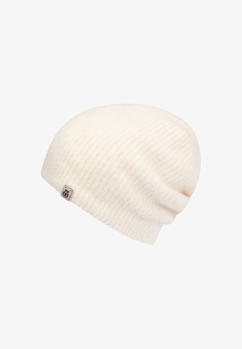 Cream-colored ribbed knit beanie with a small rectangular logo tag on the side, displayed on a white background.