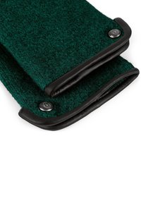 Dark green wool gloves with black leather trim and metallic button details, folded and overlapping on a white background.