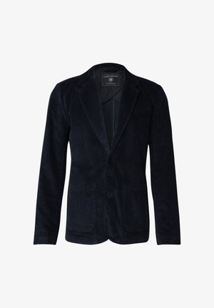 Blazer in corduroy navy con un unico bottone, due tasche frontali, texture liscia e rever a punta. Fodera visibile all'interno del colletto.