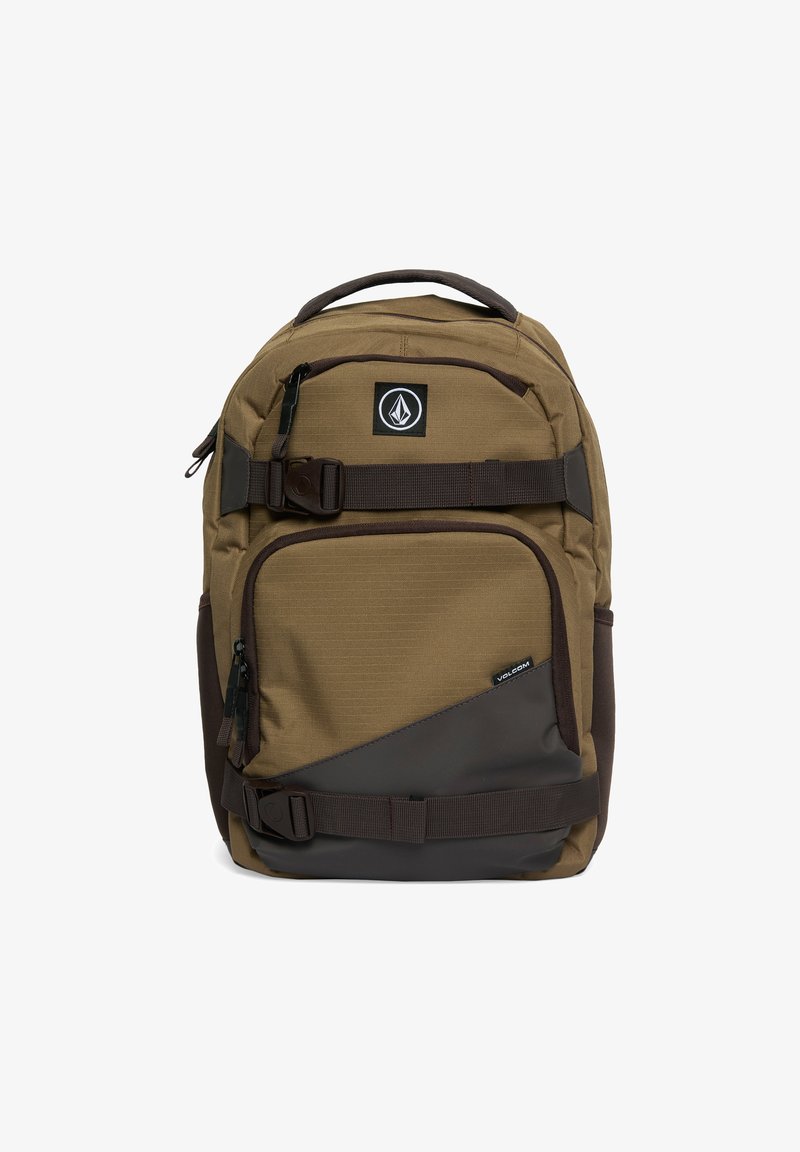 Brown fabric backpack with a textured surface, multiple zippered compartments, adjustable straps, and a side accent in a darker tone.