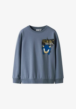 Mėlynas džemperis, pagamintas iš minkštos medžiagos, su mėlyno personažo grafika ir užrašu "SONIC SPEED" purvo stiliumi priekyje.