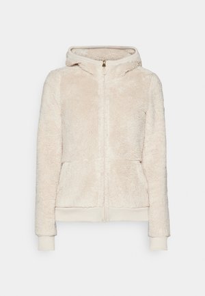 Fleece-Zip-Hoodie in hellbeige mit strukturiertem Stoff, vorderen Taschen und gerippten Bündchen und Saum. Verfügt über eine Kapuze und einen goldenen Reißverschluss.