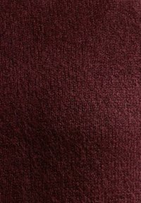 Campione di tessuto color bordeaux con un motivo di maglia testurizzato, che mostra un aspetto morbido e caldo e un colore ricco e profondo. Nessun accessorio o hardware visibile.