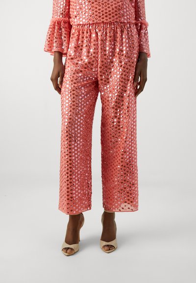 Sequined coral two-piece set featuring flared sleeves and wide-leg pants with a gathered waistband. Smooth, shiny texture with reflective accents.
