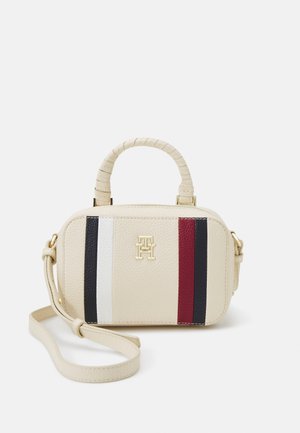 Beige leather handbag with a rounded shape, featuring red, white, and navy stripes. Gold hardware and a textured, woven handle.