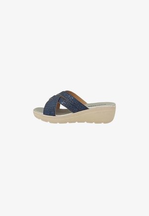 Sandalo blu con cinturini incrociati e suola beige a zeppa, progettato per un uso casual